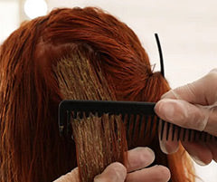 Radico natural hair dye being applied to red head.