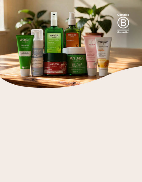 Collection of Weleda products on a wooden surface with a blurred background