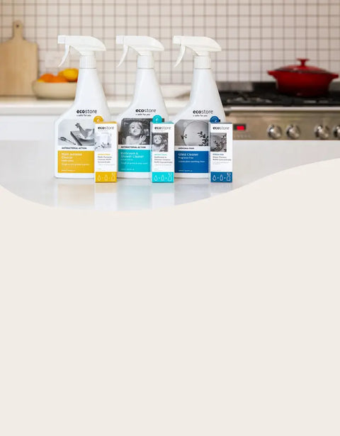 Four bottles of eco-friendly cleaning products on a kitchen counter.