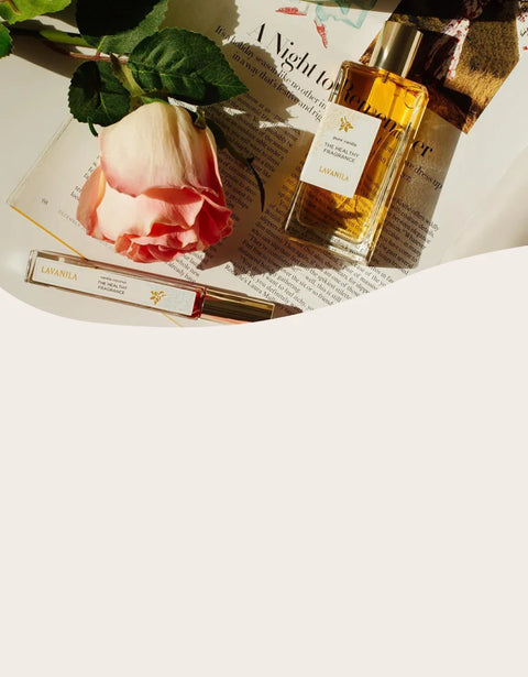 Perfume bottle and rose on a newspaper