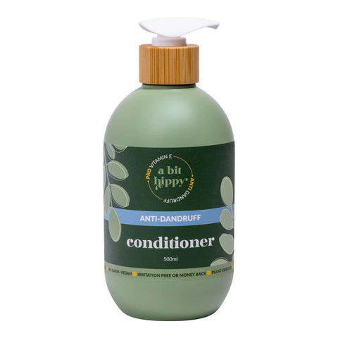 Green bottle of 'a bit hippy' anti-dandruff conditioner with a pump on a white background.