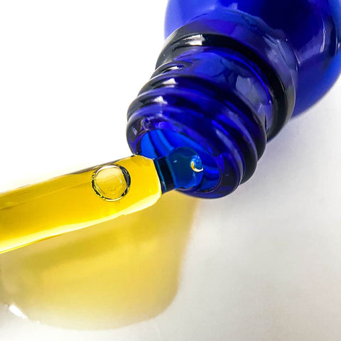 Close up of Blue Lotus Face Oil with dropper.
