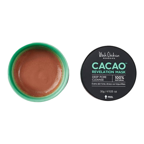 An open jar with the product inside of an organic, deeply purifying mask made with raw cacao that reduces inflammation and promotes skin regeneration to reduce the effects of acne, problem skin and ageing.