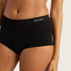 A close-up of a model wearing black high-waisted briefs with the brand name 'BOODY' printed in white on the front waistband, set against a light grey studio background.