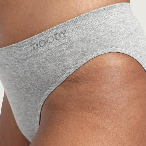 Close-up of a person wearing light heather gray underwear, showing the waistband with the brand name BOODY printed in gray.