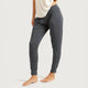 A person modelling dark grey (Storm) lounge pants with a jogger-style design & high waist, side pockets, and ribbed ankle cuffs, shown against a pale studio background.