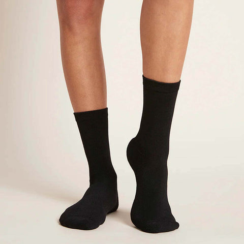 Woman wearing everyday crew socks in black.