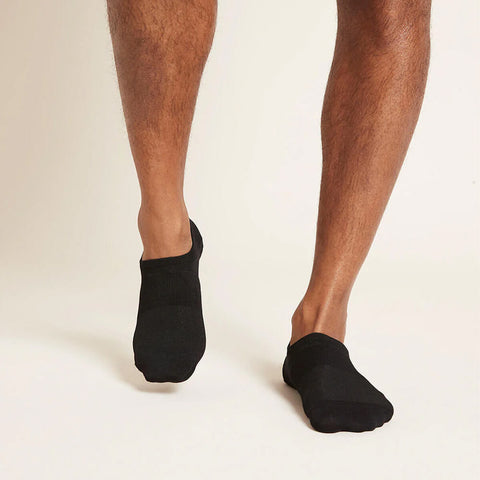 A pair of black, men's everyday hidden socks modelled on feet.