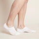 A pair of white, men's everyday hidden socks modelled on feet.