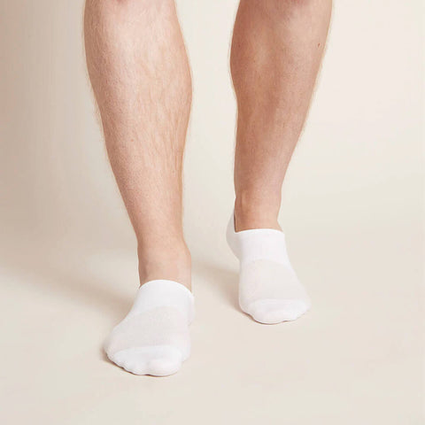 A pair of white, men's everyday hidden socks modelled on feet.