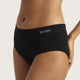 A close-up of a model wearing black high-waisted briefs with the brand name 'BOODY' printed in white on the front waistband, set against a plain light beige background.