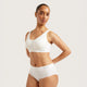 A model wearing a white Boody bralette and matching white high-waisted briefs, posed against a solid light gray studio background.