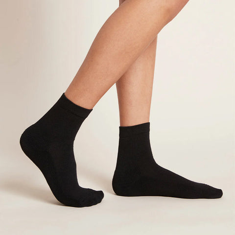 A pair of black, women's quarter crew socks modelled on feet.