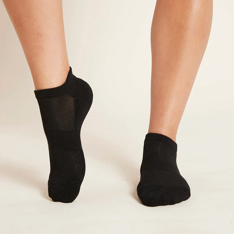 A pair of black sports ankle socks modelled on feet.