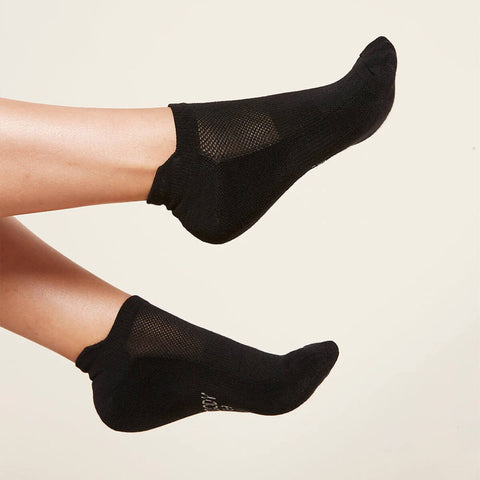 A pair of black sports ankle socks modelled on feet.