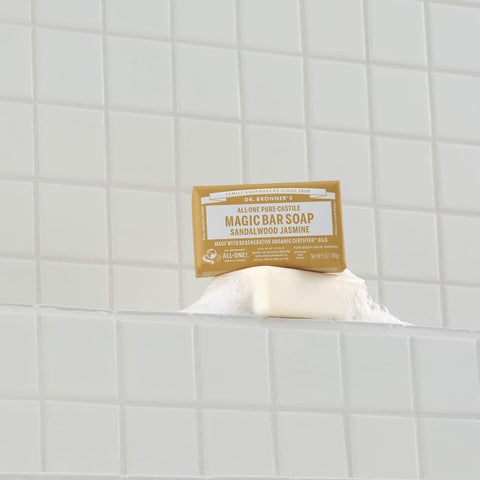 Dr. Bronner's Magic Soap Bar - Sandalwood Jasmine 140g with a label on a white tiled background.
