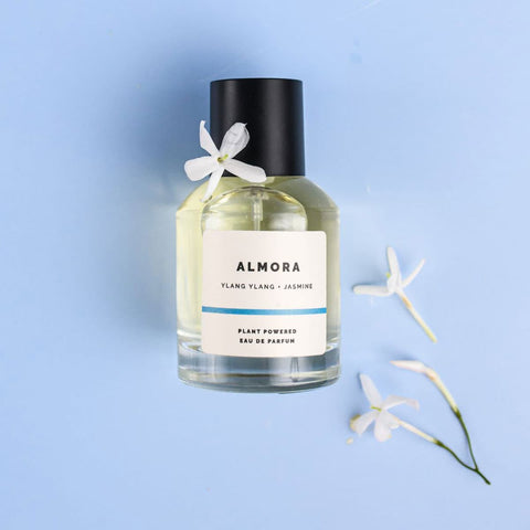 ECO. Modern Essentials Almora 50ml natural perfume bottle with jasmine flowers on a light blue background.