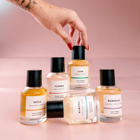 Collection of ECO. Modern Essential natural perfume bottles with visible labels on a pink background.