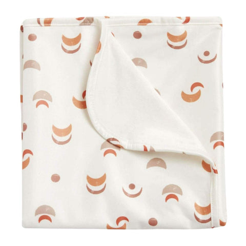 Folded change mat with desert moon pattern. 