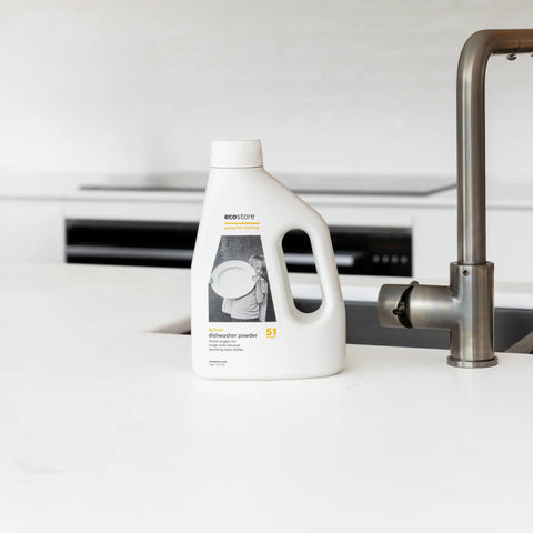 Bottle of ecostore Dishwasher Powder on a white kitchen counter.