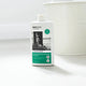 Bottle of all purpose cleaner on a clean white floor next to a white metal bucket.