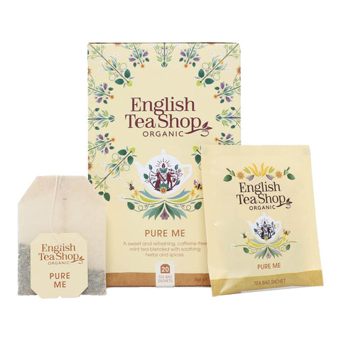 A box of organic Pure Me tea, a sweet and refreshing, caffeine-free mint tea blended with soothing herbs and spices, with a tea bag and its packet in front of it.