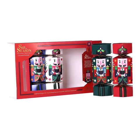 A Christmas nutcracker-themed gift set featuring a red box with nutcrackers visible inside, plus two loose nutcracker crackers standing outside.