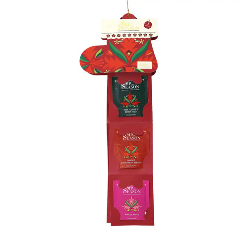 A hanging Christmas gift set display card featuring three 'Sip Season' tea bags in red, green, and pink packaging.