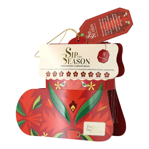 A packaged set of festive tea, featuring a red and green design on the carded packaging with a tag.