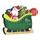 A Christmas-themed cardboard standee or sign featuring Santa Claus in a sleigh with a decorated tree, gifts, and text reading 'Sip the Season'.