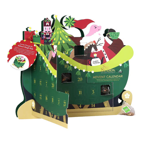 A festive Santa Claus advent calendar shaped like a sleigh with green panels, numbered doors, a Christmas tree, nutcracker, and illustrated Santa and reindeer.