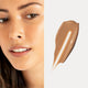 Oat Milk Foundation swatch in Maple shade (medium neutral) next to a model wearing the same shade.