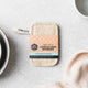 Set of 2 Loofah Dish Sponges pictured with packaging on a marble bench with textural elements.