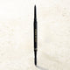 Eyebrow pencil with 'Eye of Horus' branding on a light beige background