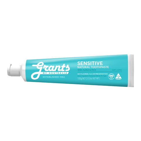 A tube of sensitive, natural toothpaste with xylitol and mint.