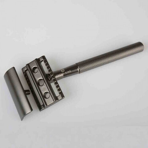 Dark grey safety razor taken apart.