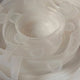 A close-up of a stack of translucent white silicone lids.