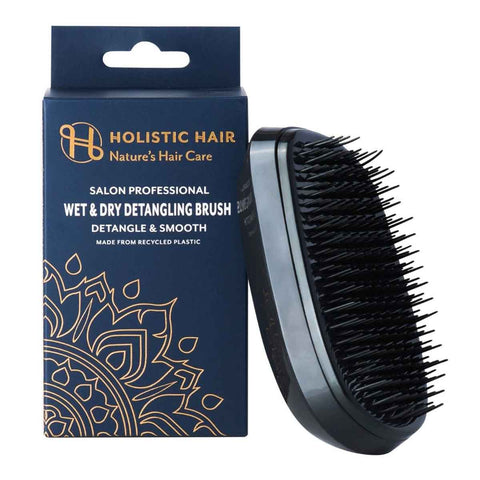 Salon professional wet & dry detangling brush by Holistic Hair. Brush pictured next to packaging on a white background.