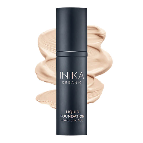 Bottle of INIKA Organic Liquid Foundation with a nude-coloured swatch behind it.
