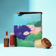 INika Organic lip care products including a lip mask, lip crayon, and tinted lip balm on a blue background.