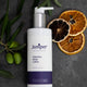 Bottle of body lotion on grey background with dried citrus slices and olives. Suitable for all skin types.