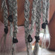 Close-up of braided hair extensions with black clips on a blurred background