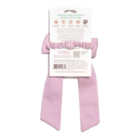 Violet Ice (pink) coloured satin bow ribbon with back of packaging on a white background
