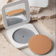 Mineral Goddess Pressed Foundation mirror compact on a stone background with pan removed. 