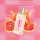 Perfume bottle labeled ' Lavanila Vanilla Grapefruit' with grapefruit slices and product details on a pink background.