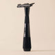 Black razor on a beige background