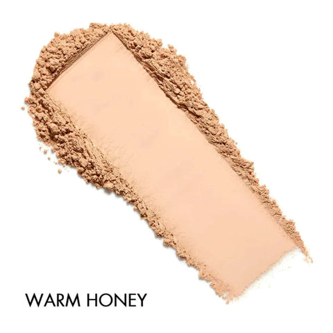 Cosmetic powder sample with 'Warm Honey' label on a white background