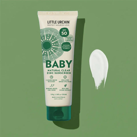 Tube of Little Urchin Baby Natural Clear Zinc Sunscreen on a green background.