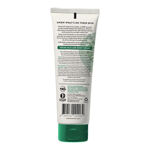 The back of a white squeeze tube of baby sunscreen, featuring green accents, a green cap, and extensive black text detailing ingredients and certifications.