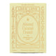 A pale yellow rectangular box of Loco Love Almond Caramel Crunch chocolate, featuring elegant tan typography and decorative borders, with 'Artisanal' printed vertically on the sides.